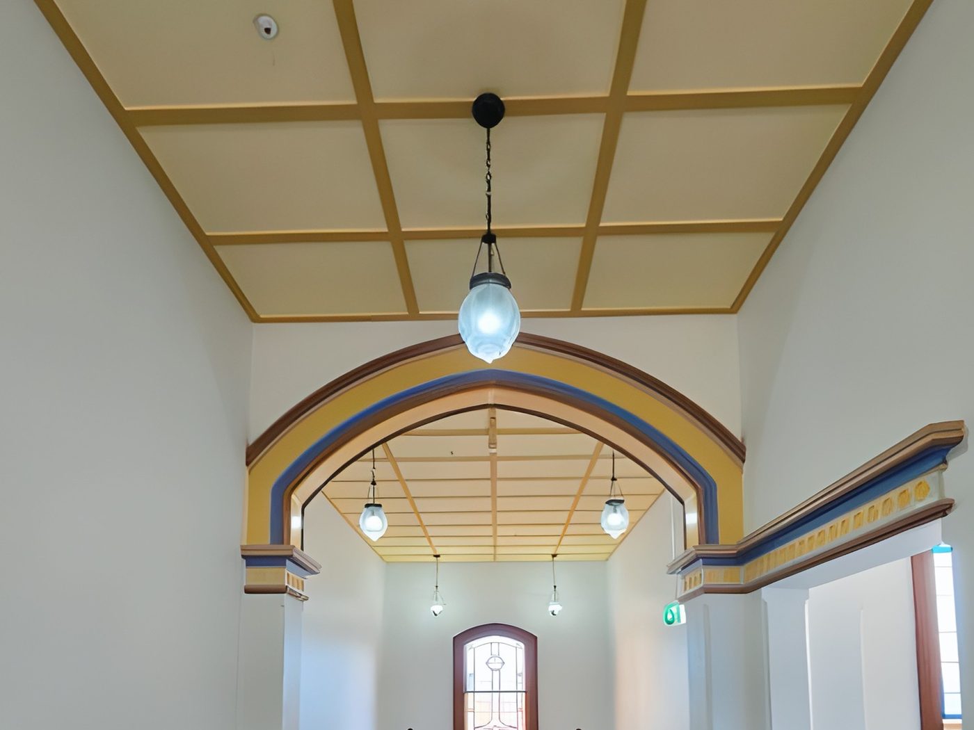 After: The same heritage hall archway after restoration, repainted in its original colours