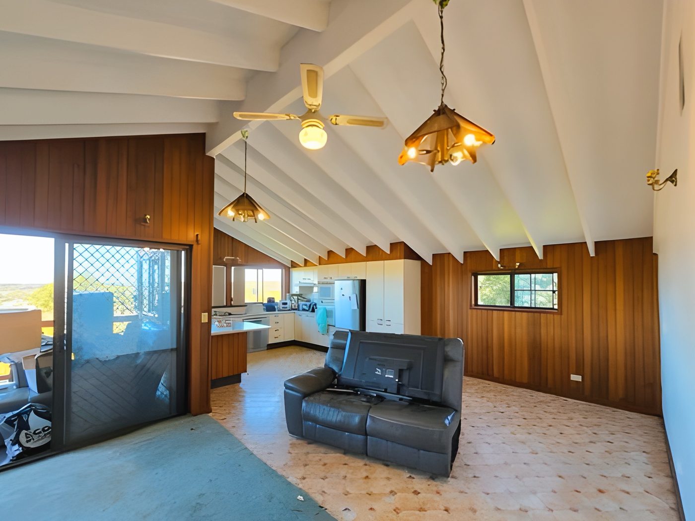 After: The same living room after the raked ceiling was painted white
