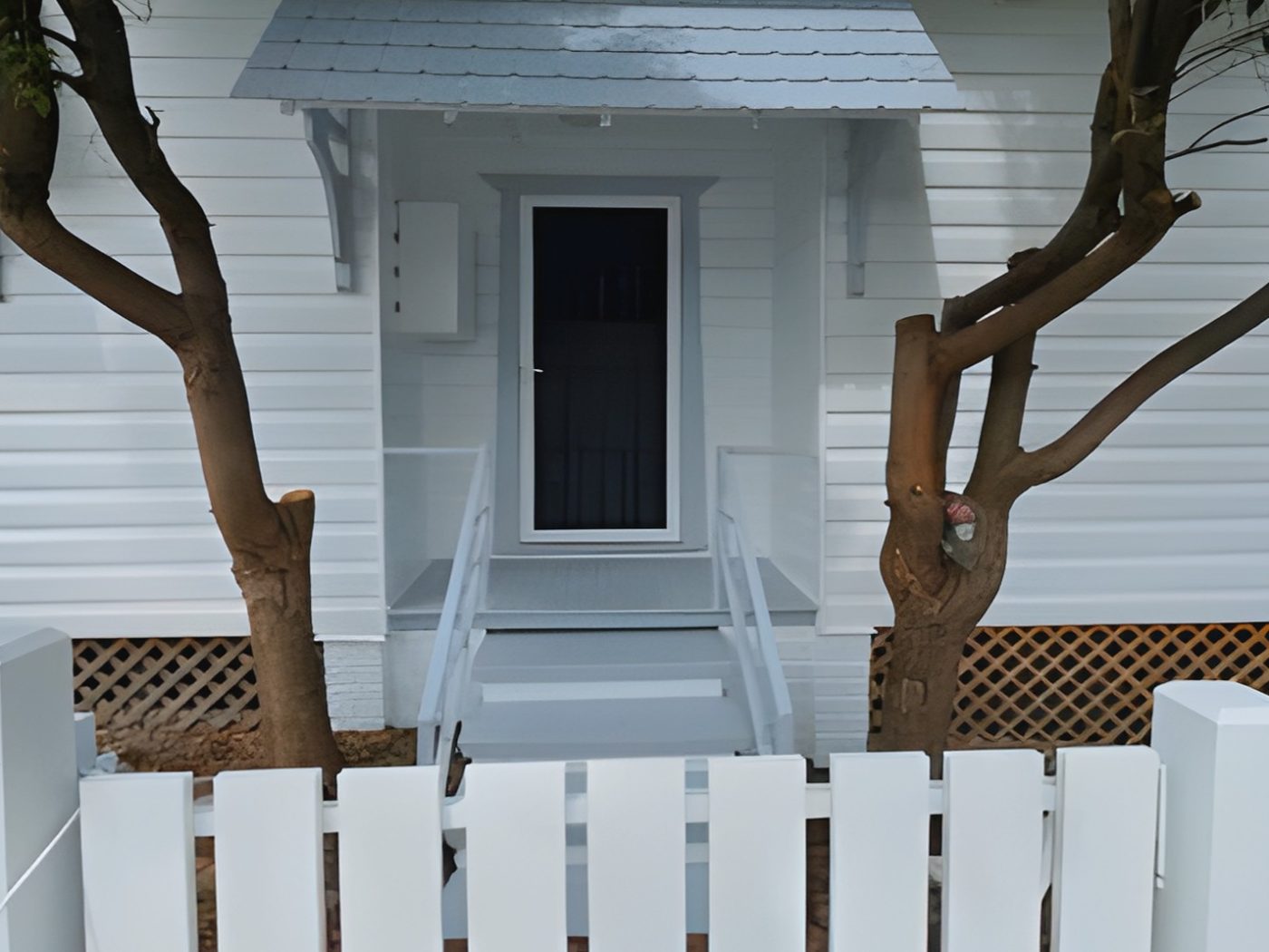 After: The same weatherboard cottage entry after it was repainted in white