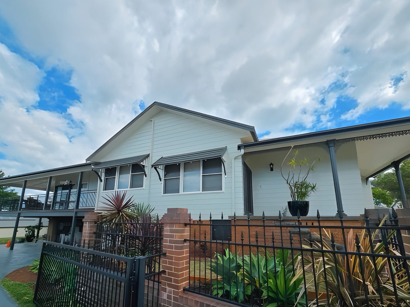 After: The same weatherboard home after its exterior repaint, completed at height