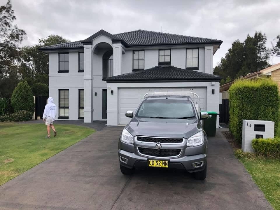 After: The same modern two storey home after its exterior repaint in light grey