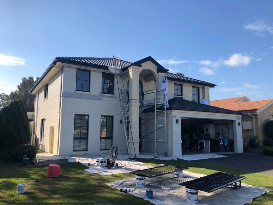Before: Rendered two storey home during preparation, with scaffolding and drop sheets