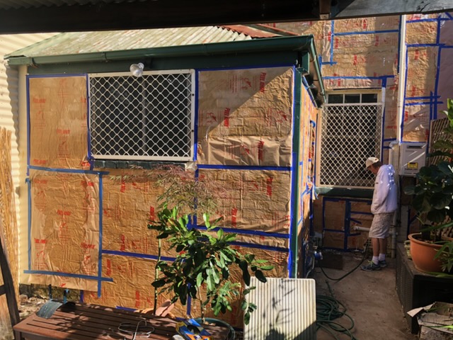 Specialist paint removal, with the building masked and sealed before old paint is removed