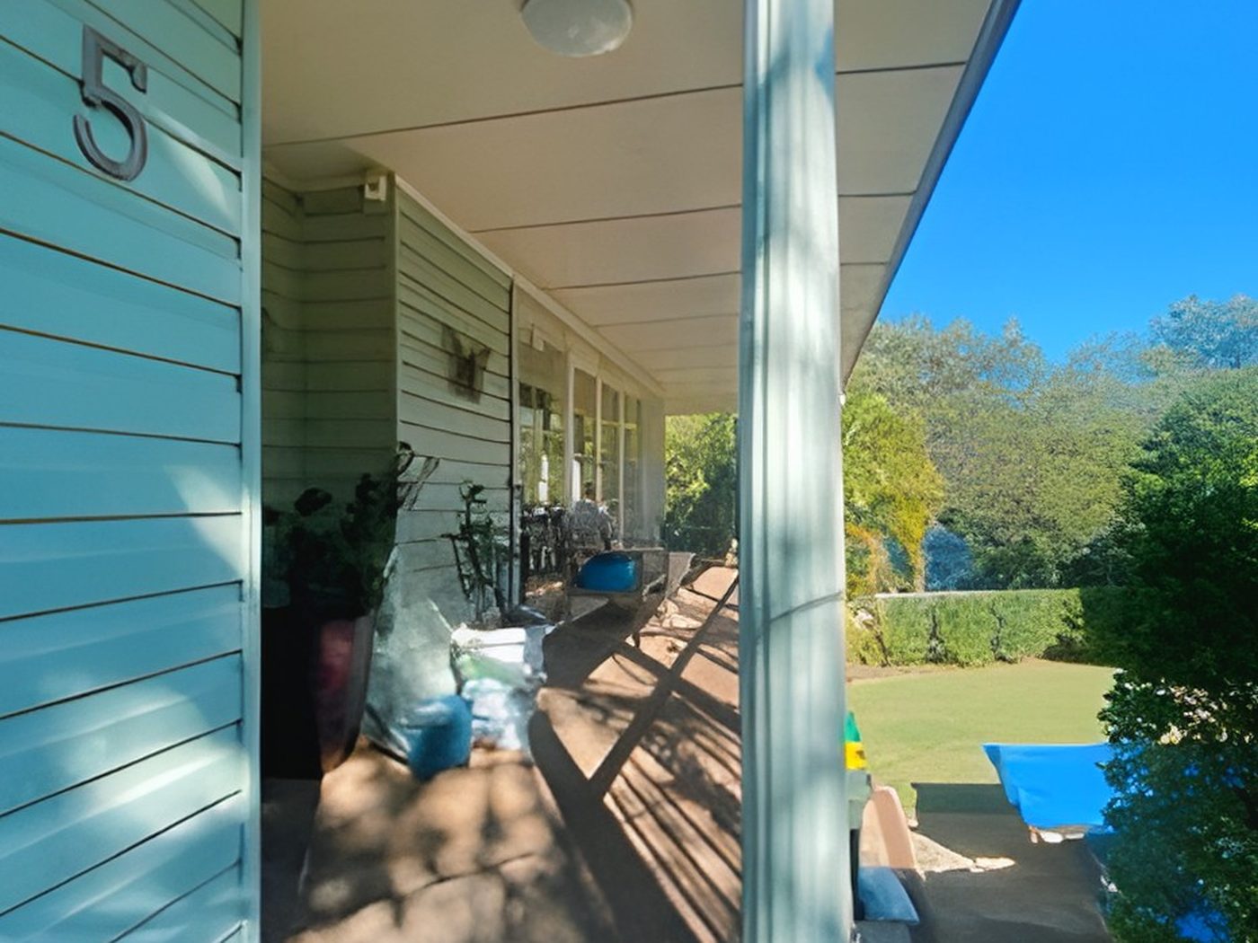 Before: Weatherboard verandah before painting, in mint green