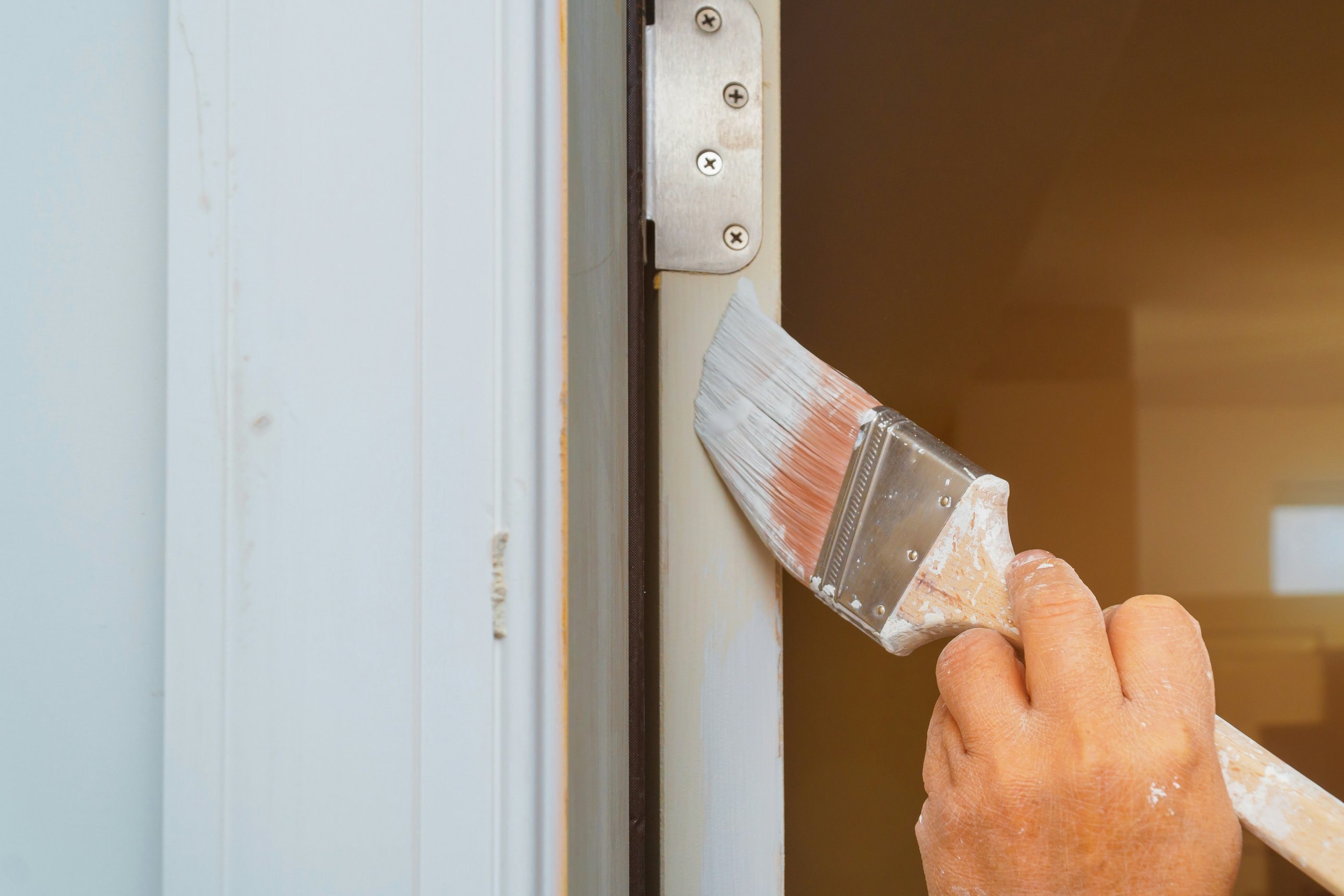 Painter brushing a door frame, Andrew Lindner Painting Newcastle